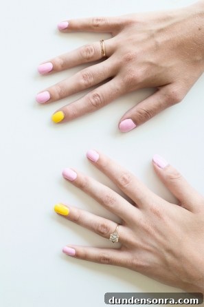 Someone with pink and yellow nails