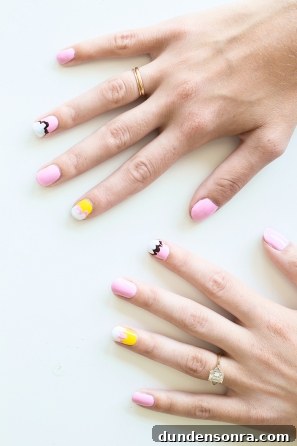 Someone with pink and yellow nails