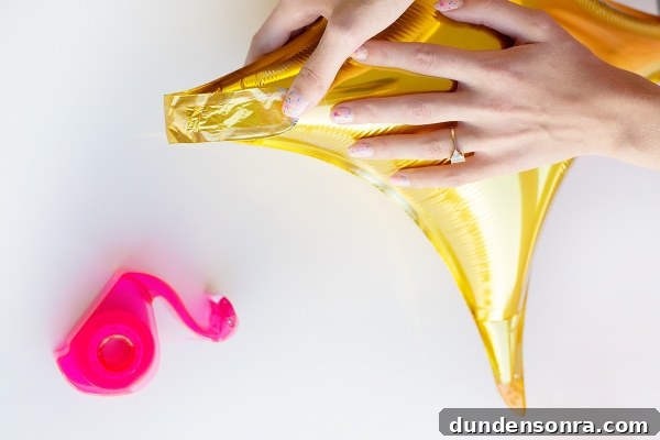 Someone holding a gold balloon