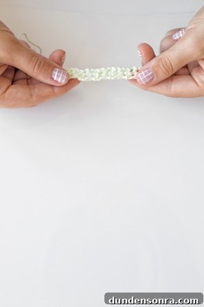 Someone holding a white knitted item