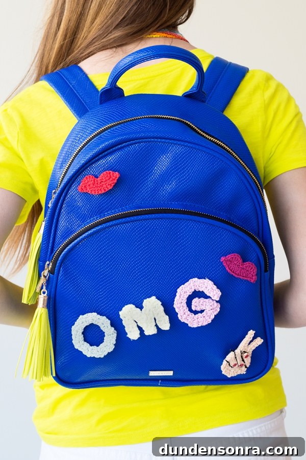 Someone wearing a blue backpack that says "omg"