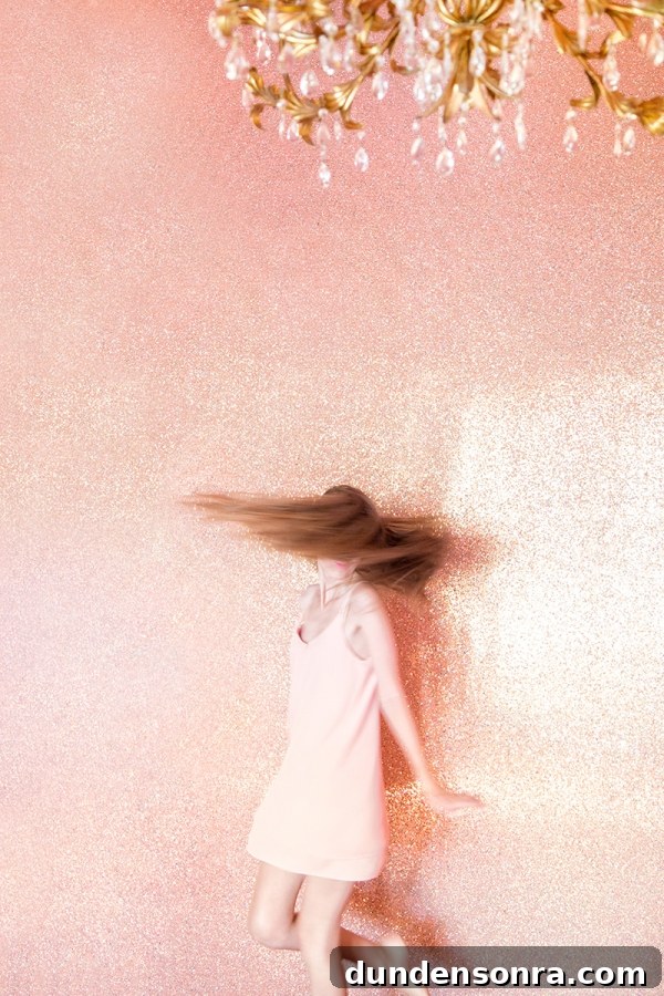 Someone spinning in front of a pink wall