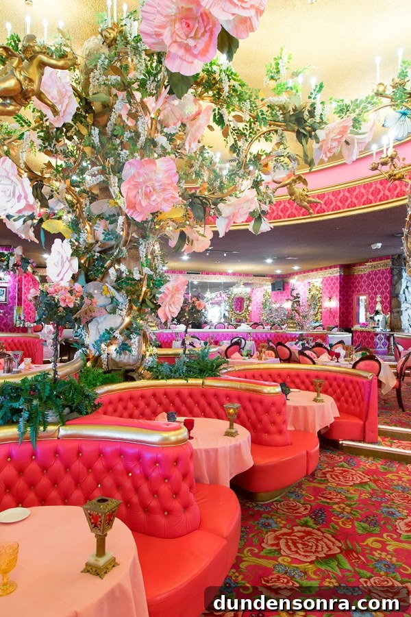 A room with pink couches and flowers