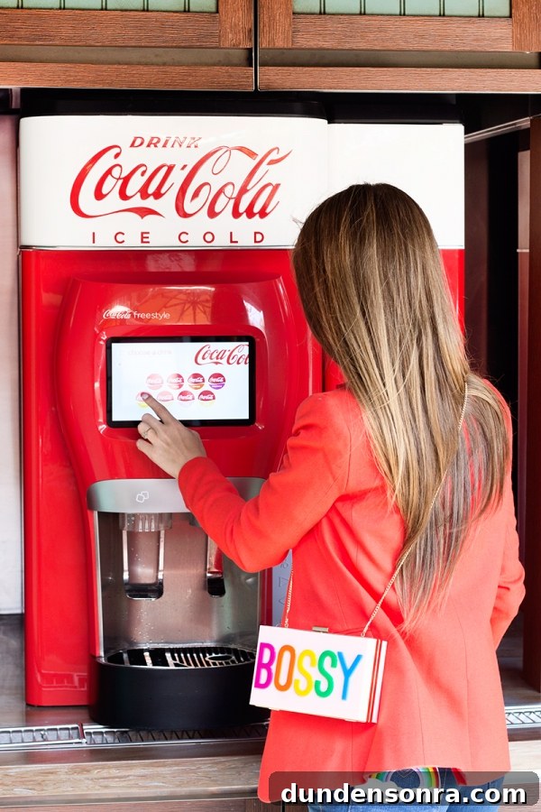 3 Bold Colorful Fall Outfits to Elevate Your Wardrobe 6 A woman ordering a drink from a machine