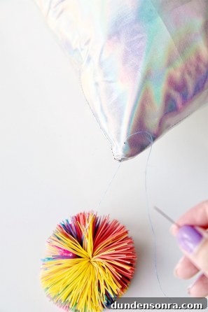 A close up of a pillow corner and a colorful ball