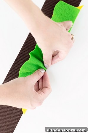 DIY Burger Costume Ideas: Creative Homemade Burger Halloween Outfit 9 Someone gluing a green material onto a black material