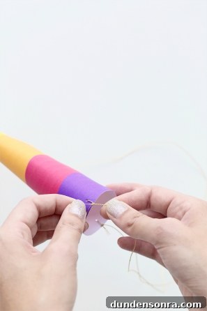 DIY Lisa Frank Costume Ideas for Colorful 90s-Inspired Looks 12 Someone tying string on a purple paper