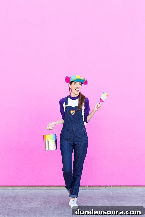 DIY Lisa Frank Costume Ideas for Colorful 90s-Inspired Looks 4 A woman wearing overalls and a rainbow hat