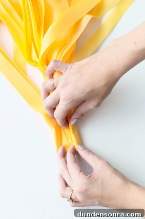 Someone folding yellow paper