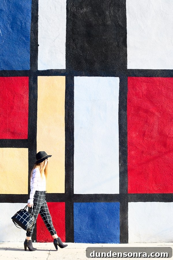 A woman standing in front of a colorful wall
