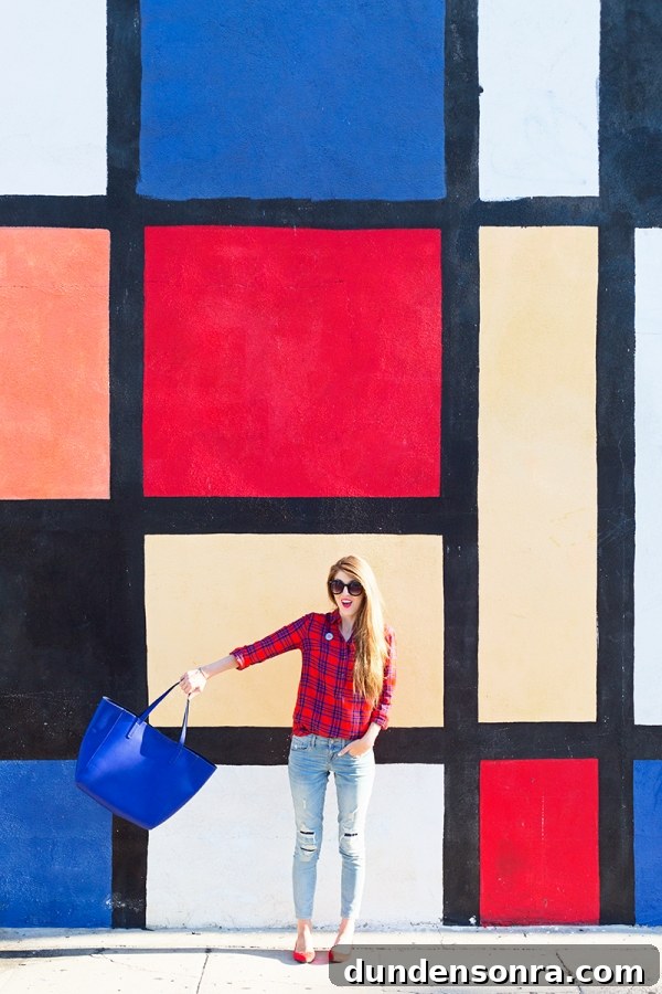 A woman standing in front of a colorful wall
