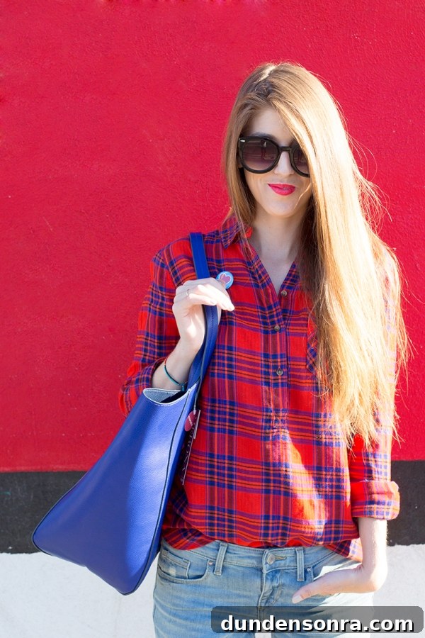 A woman standing in front of a red wall