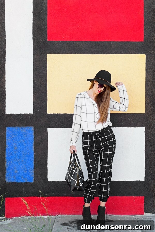 A woman standing in front of a colorful wall