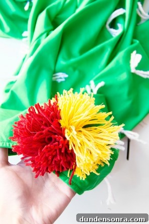 A green shirt with white strings and fake flowers