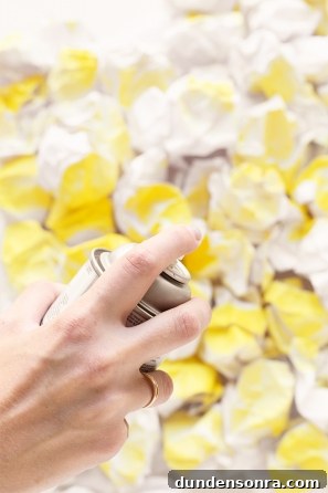 Someone spraying painting something yellow