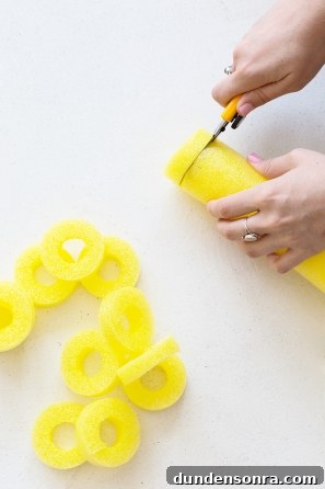 Someone cutting colorful pool noodles 