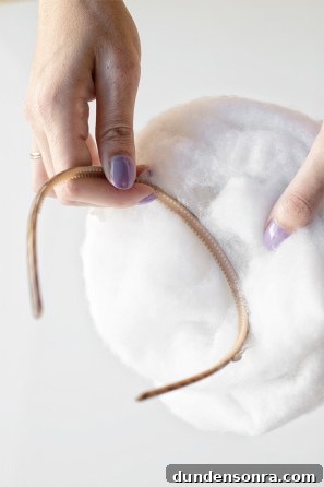 Someone holding cotton and a hairband 