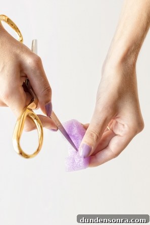 Someone cutting a purple styrofoam ring 
