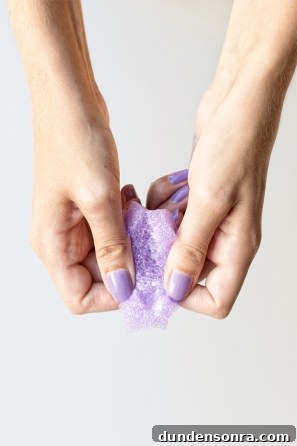 Someone holding a purple styrofoam ring 