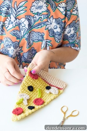 Someone sewing a slice of pizza