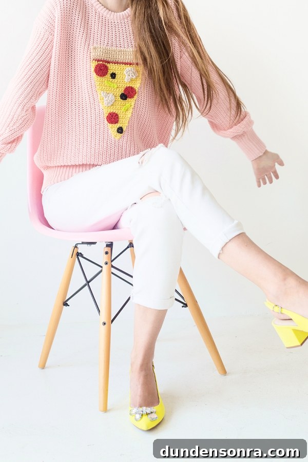 Someone wearing a pizza sweater and white jeans