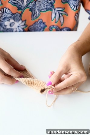 Someone sewing something beige 
