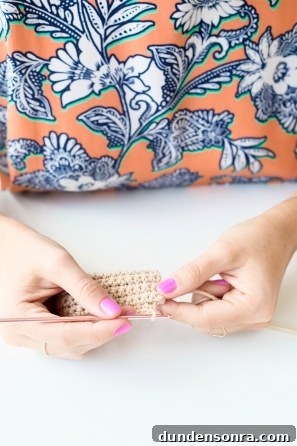 Someone sewing something beige 
