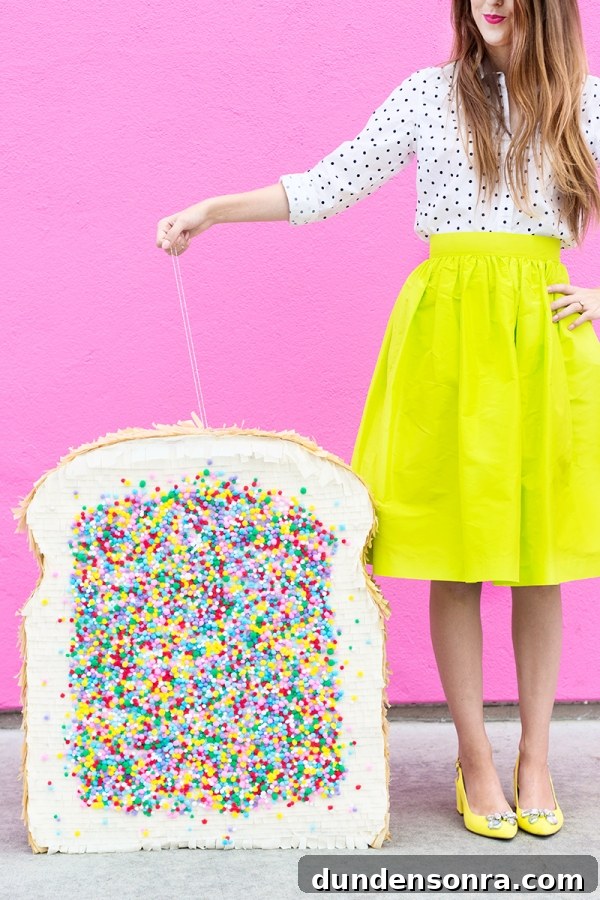 A woman in a yellow skirt and holding a fairy bread pinata 