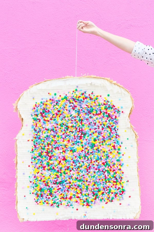Someone holding a fairy bread pinata 