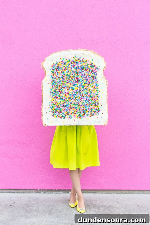 A woman in a yellow skirt and holding a fairy bread pinata 