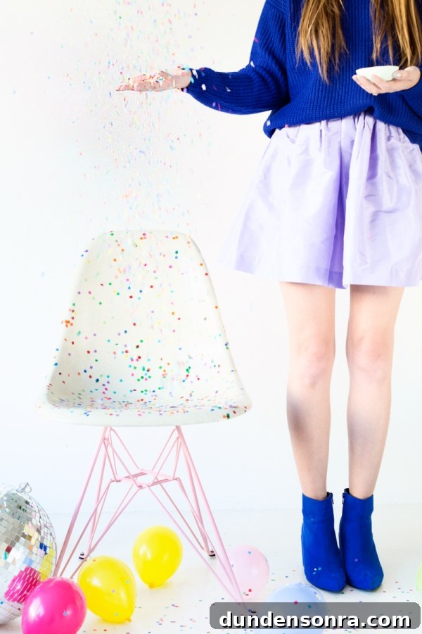 Studio DIY and Modernica Confetti Chair Reveal + Giveaway 2 A chair with colorful dots and a person standing next to it