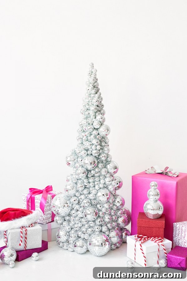 A silver Christmas tree and pink presents