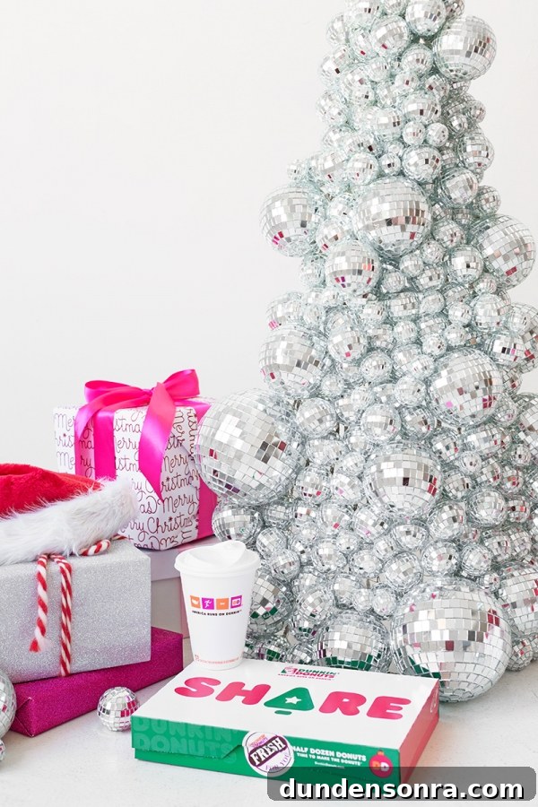 A disco ball Christmas tree and pink presents 