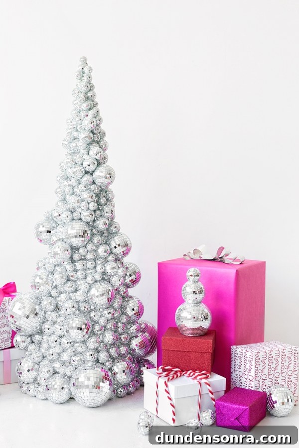 A disco ball Christmas tree and pink presents