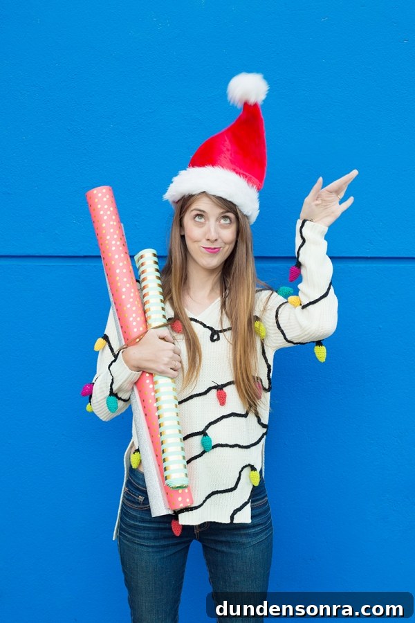 A woman wearing a santa hat and holding wrapping paper