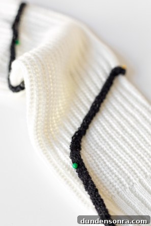 Black yarn on a white sweater