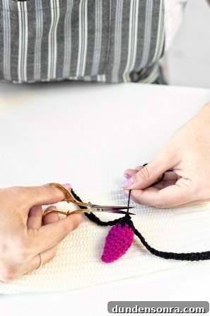 Someone cutting black yarn