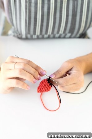 Someone sewing something orange