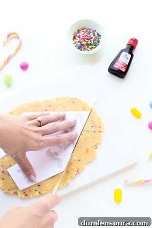 Funfetti Sugar Cookie House Recipe — Colorful Party Treat 7 Someone putting paper on dough
