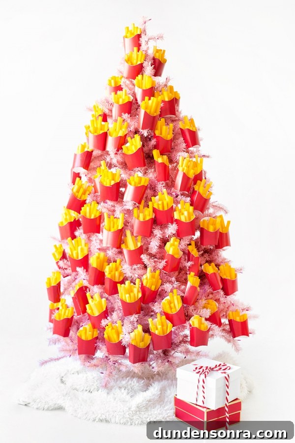 A pink christmas tree covered in fry ornaments 