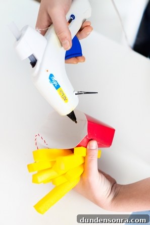 Someone gluing a fry holder 