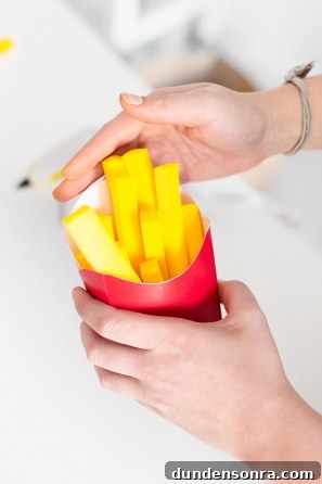 Someone holding a fake pack of fries