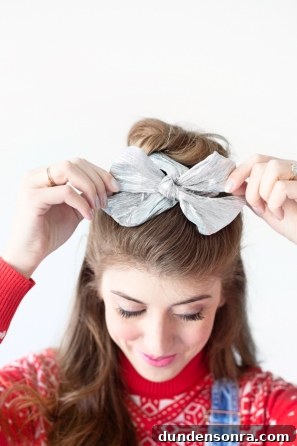 Sparkling Holiday Outfit Ideas: Head-to-Toe Party Looks 11 A woman with a silver bowtie in her hair