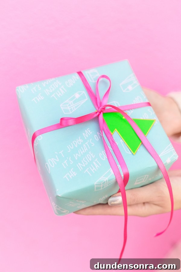 4 Stylish Holiday Gift Wrap Pairings to Impress Recipients 5 Someone holding a present wrapped in blue wrapping paper