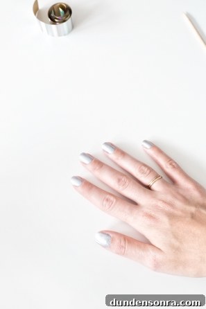 Someones hand with silver nails