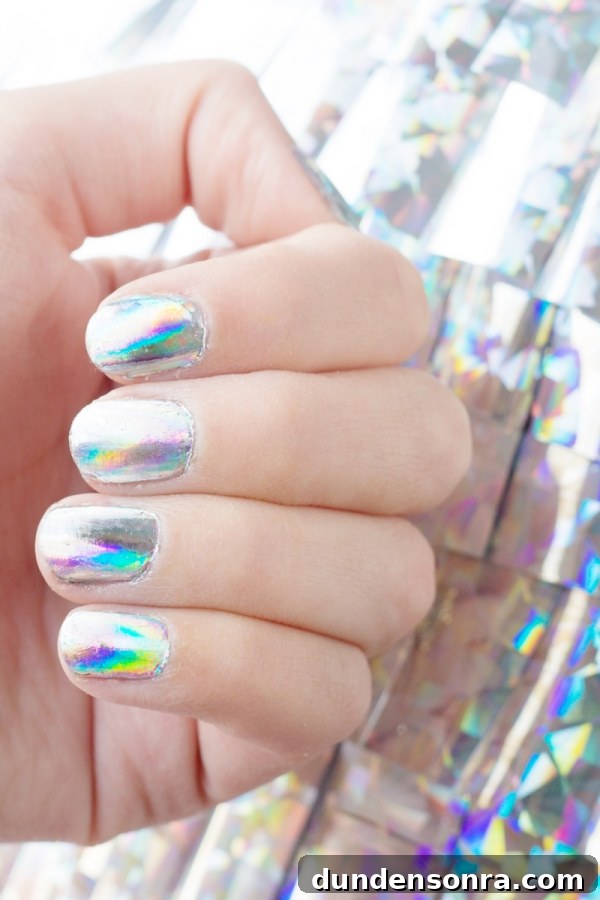 A hand with holographic nails 