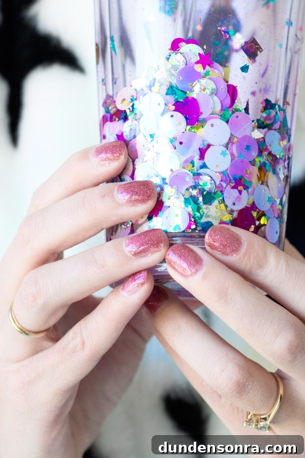 How to Make a Floating Glitter Tumbler: Step-by-Step Guide 7 Someone holding a glitter cup