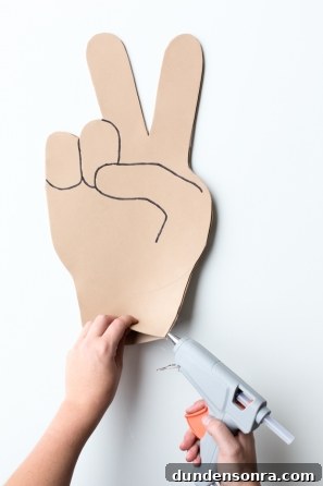 How to Make Emoji Foam Fingers: DIY Guide with Templates 8 Someone gluing an emoji craft