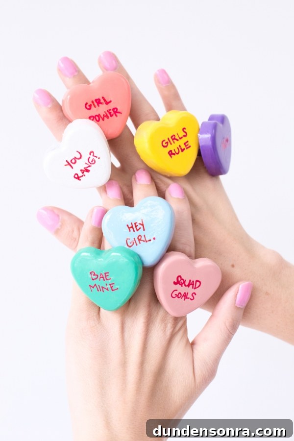 DIY Conversation Heart Rings: Make Cute Candy Heart Jewelry at Home 2 A hand with rings on it