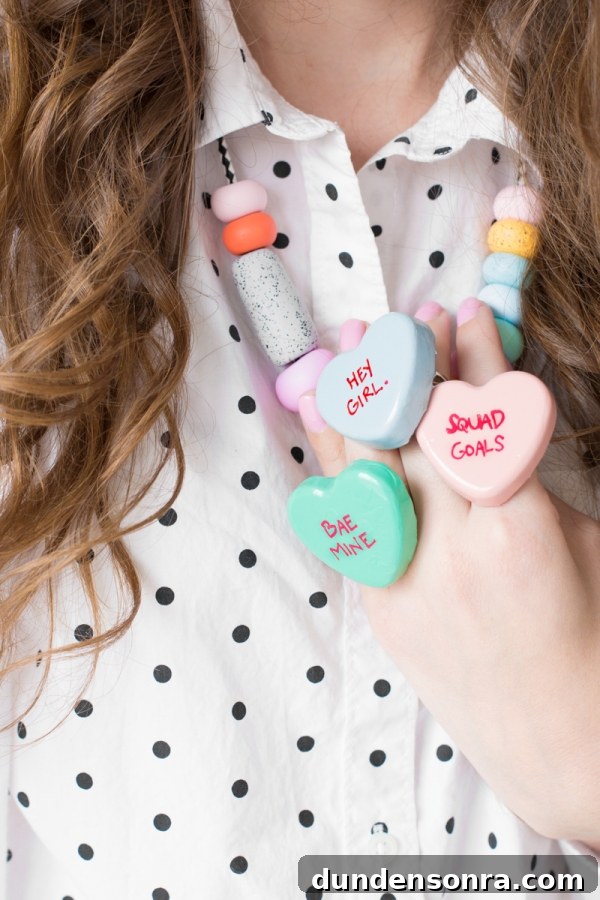 DIY Conversation Heart Rings: Make Cute Candy Heart Jewelry at Home 3 A woman with heart rings on her hand